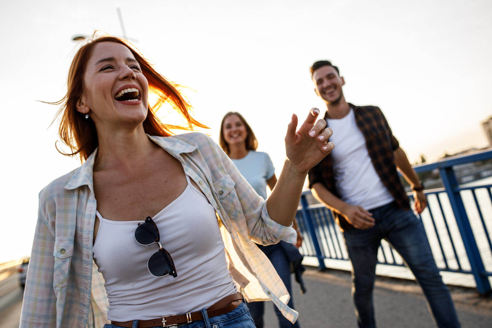Group Of Friends Hangout At The City Street.They Walking Over The Bridge And Joying In Sunset.